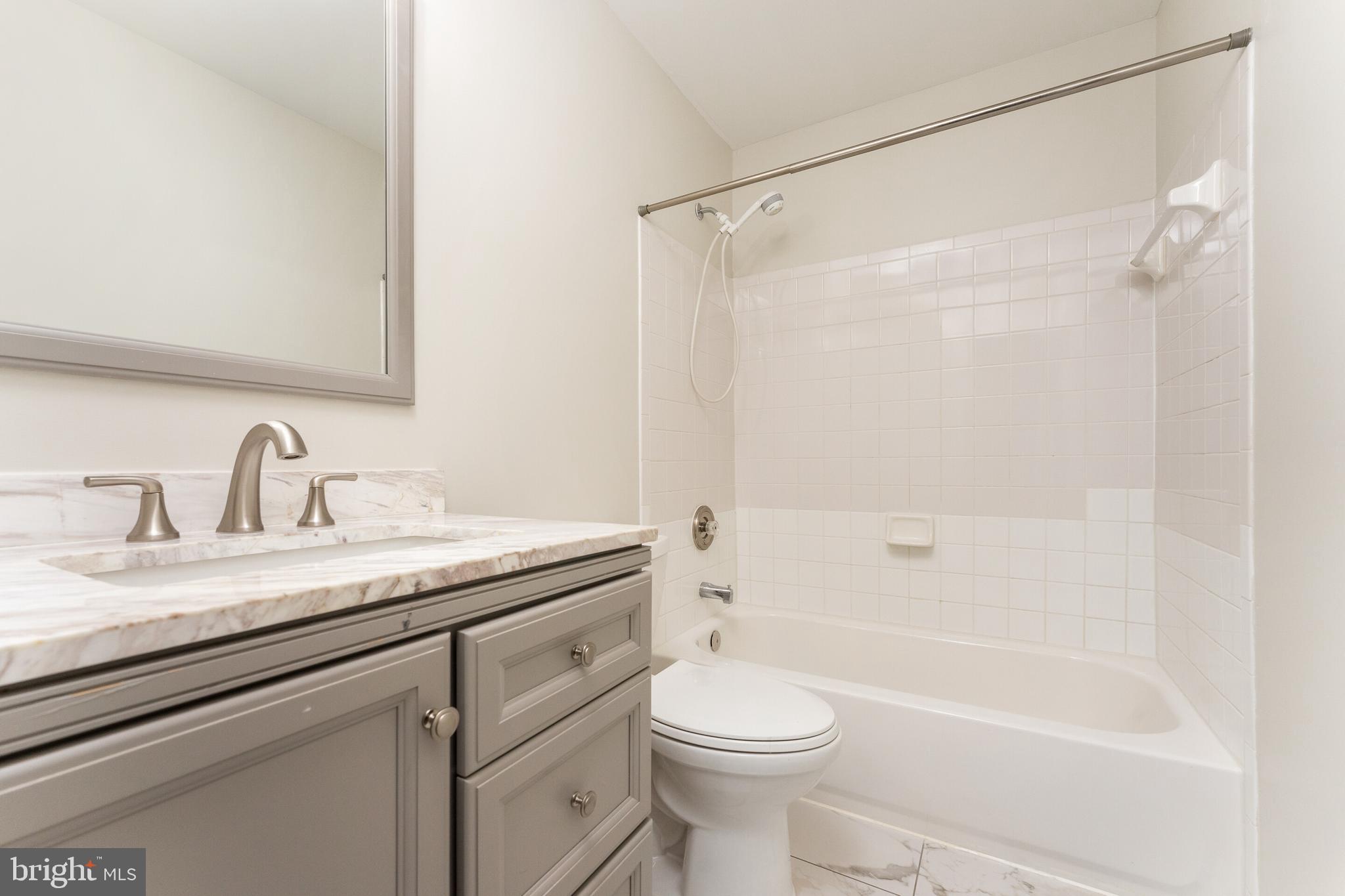 5311 Yellow Turtle Place Woodbridge, VA 22193 - Photo 23 of 36 a bathroom with a granite countertop sink toilet and shower