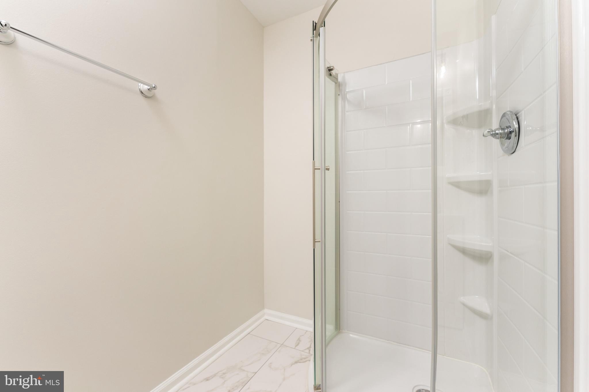 5311 Yellow Turtle Place Woodbridge, VA 22193 - Photo 10 of 36 a bathroom with a glass shower door