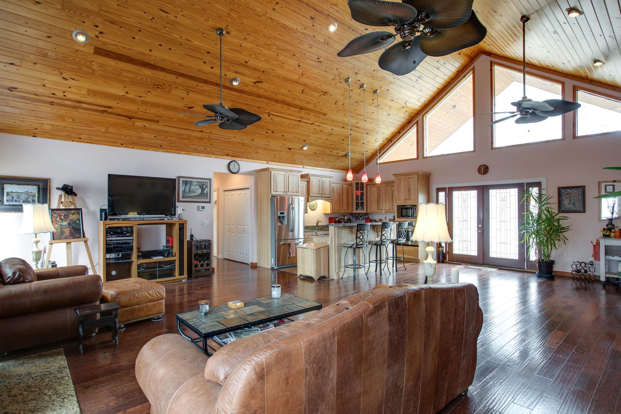 5150 Jefferson Road Smithville, TN 37166 - Photo 4 of 29 An alternate view of the Living Room and Kitchen looking back toward the front doors. Large windows on either end of the expansive room let in tons of natural light!