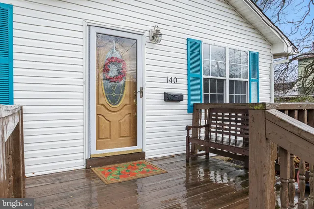 a front view of a house with barbeque and plants