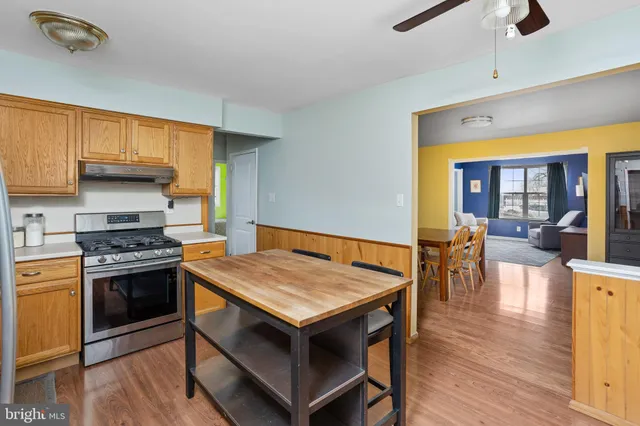 a kitchen with a stove and a wooden floors