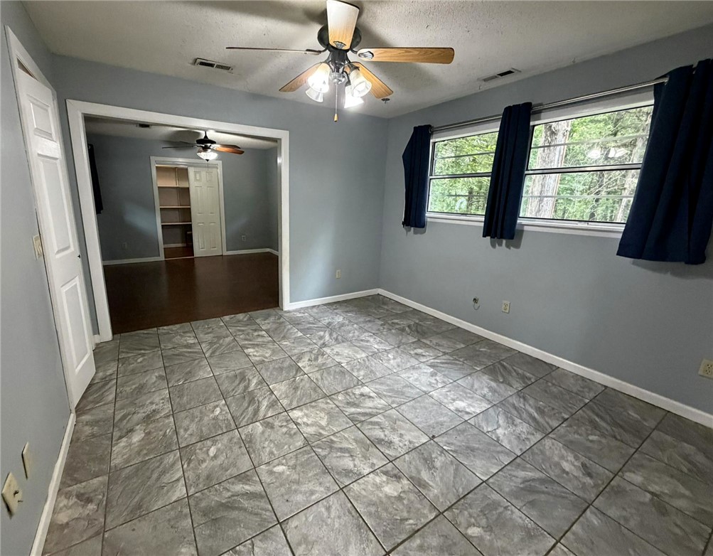5108 Ridge Road Alma, AR 72921 - Photo 18 of 33 Room featuring gray tile flooring, light gray walls, and white trim