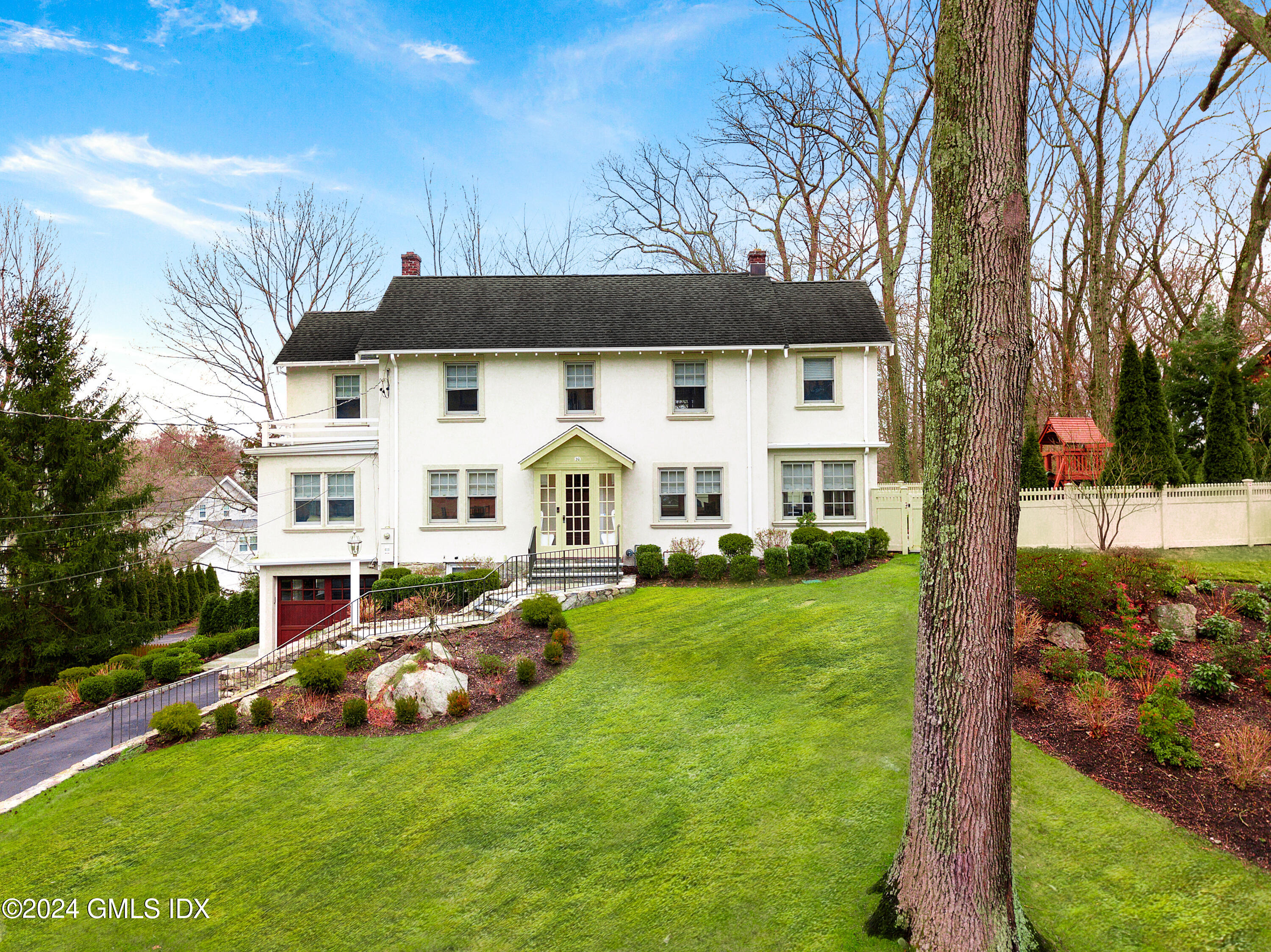 93 Valleywood Road Cos Cob, CT 06807 - Photo 1 of 22 front view of house with a yard