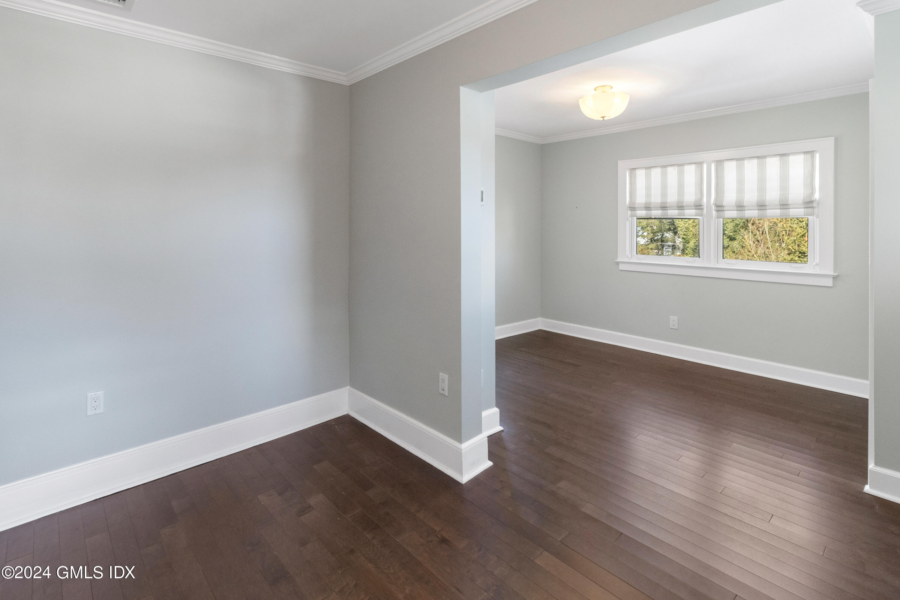 93 Valleywood Road Cos Cob, CT 06807 - Photo 14 of 22 an empty room with wooden floor and windows