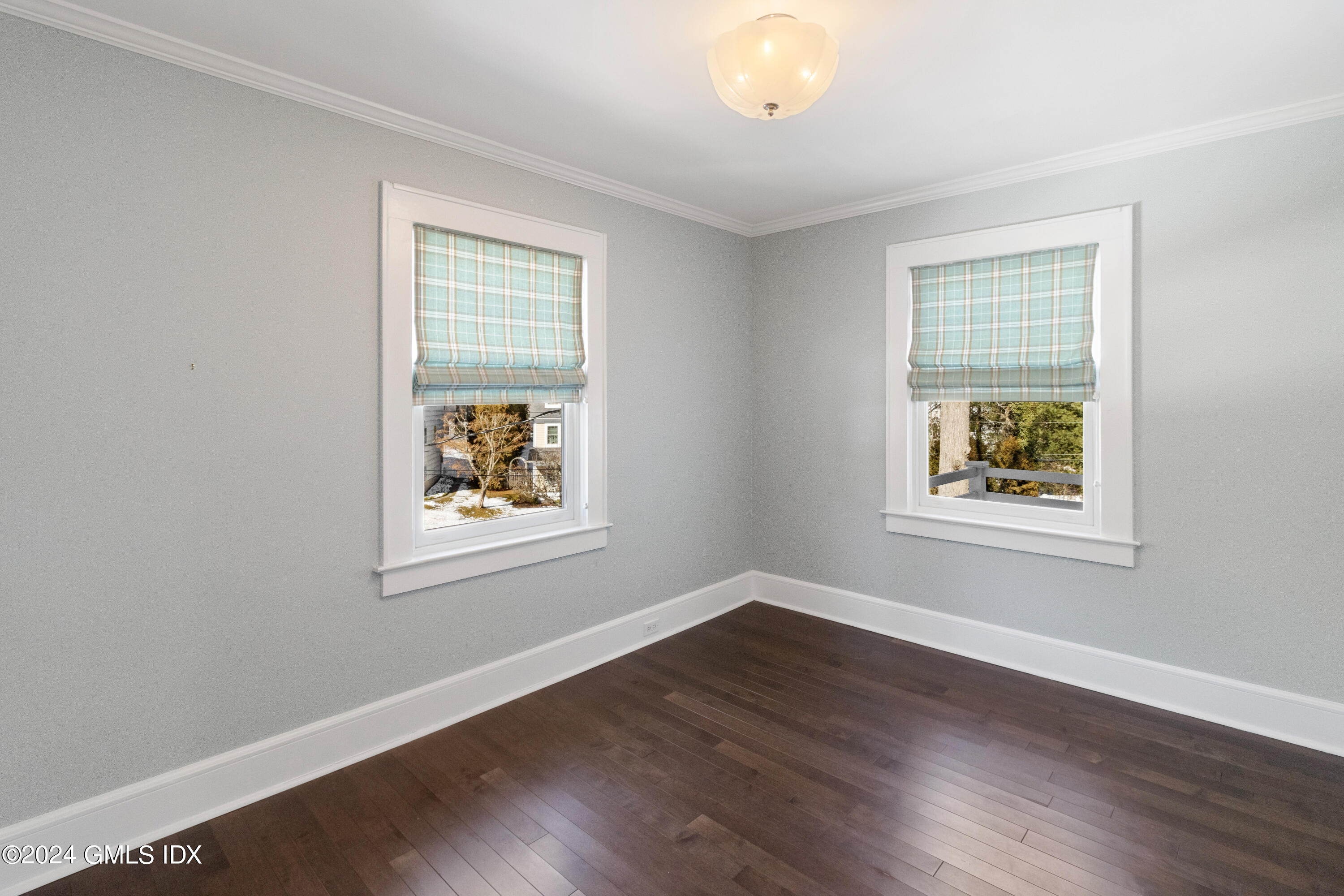 93 Valleywood Road Cos Cob, CT 06807 - Photo 15 of 22 a view of an empty room with wooden floor and a window