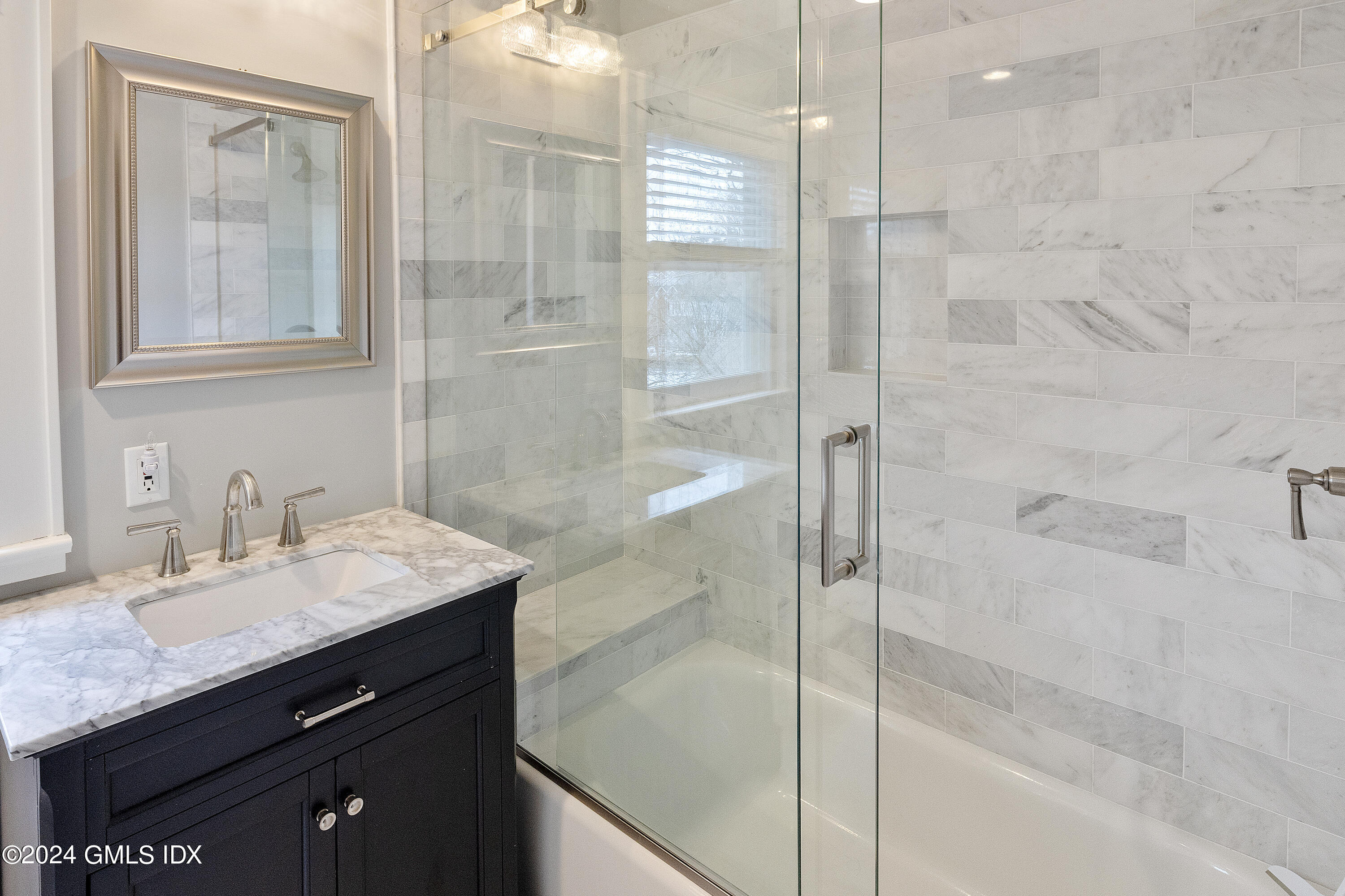93 Valleywood Road Cos Cob, CT 06807 - Photo 16 of 22 a bathroom with a granite countertop sink a mirror and shower