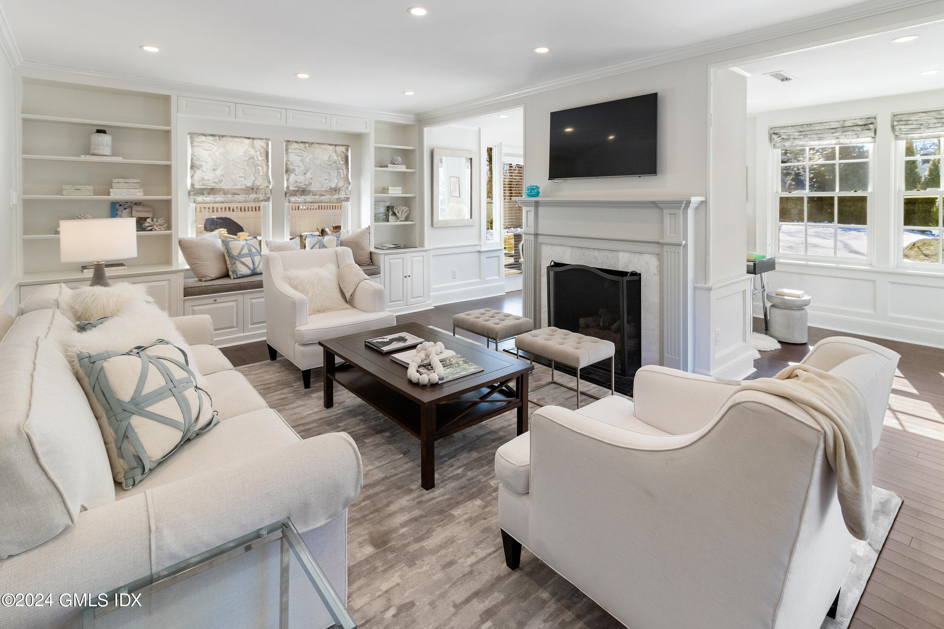 93 Valleywood Road Cos Cob, CT 06807 - Photo 2 of 22 a living room with furniture a flat screen tv and a fireplace