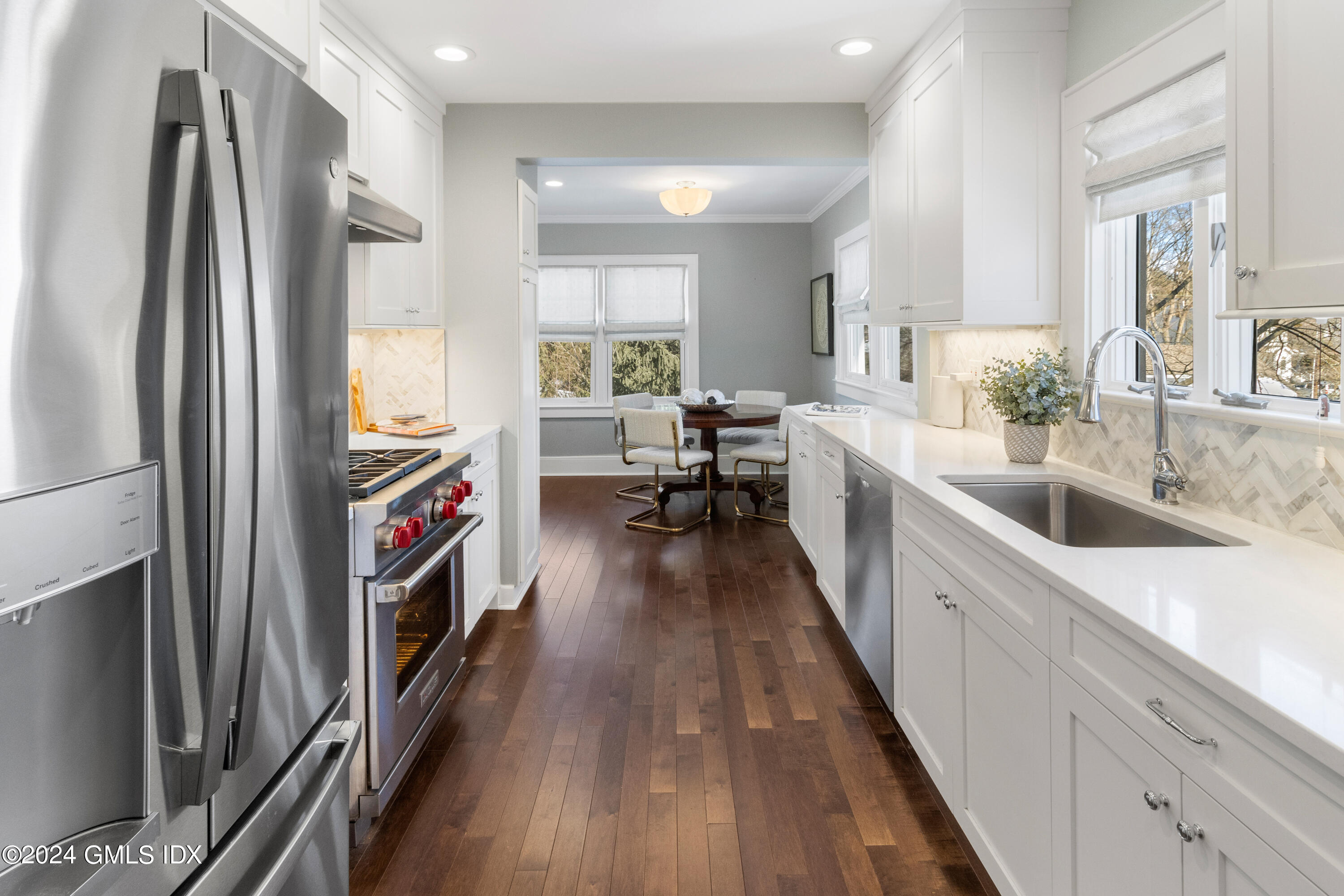 93 Valleywood Road Cos Cob, CT 06807 - Photo 8 of 22 a kitchen with refrigerator a sink and wooden floor