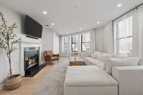 a view of a dining room with furniture and chandelier