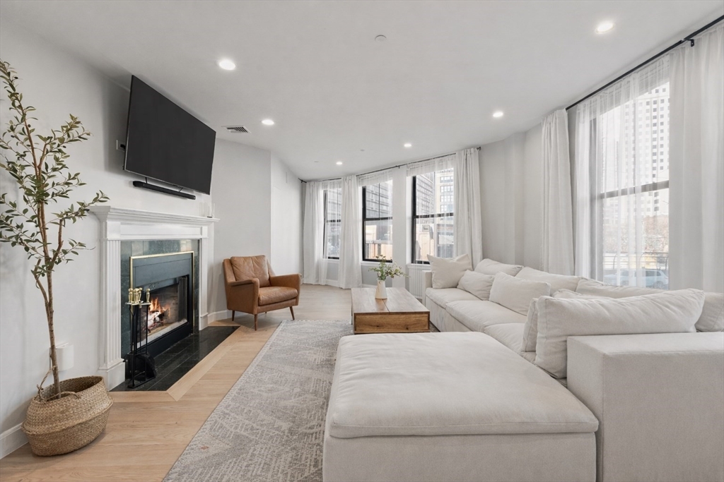 75 Clarendon Street, Unit 201 Boston, MA 02116 - Photo 2 of 12 a living room with furniture fireplace and flat screen tv