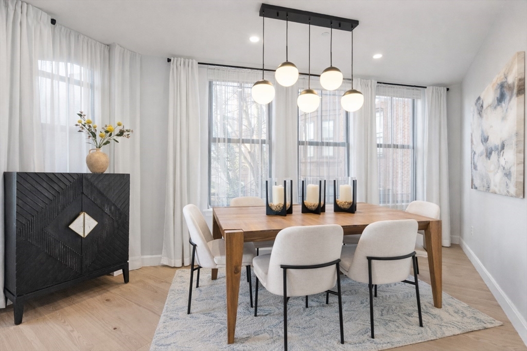 75 Clarendon Street, Unit 201 Boston, MA 02116 - Photo 3 of 12 a view of a dining room with furniture and chandelier
