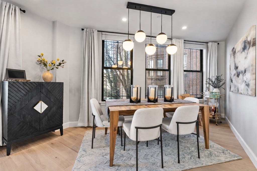 75 Clarendon Street, Unit 201 Boston, MA 02116 - Photo 3 of 15 a dining room filled chandelier and wooden floor