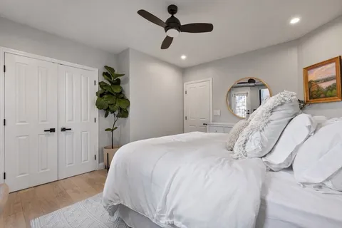 a bathroom with a granite countertop sink a toilet and a mirror