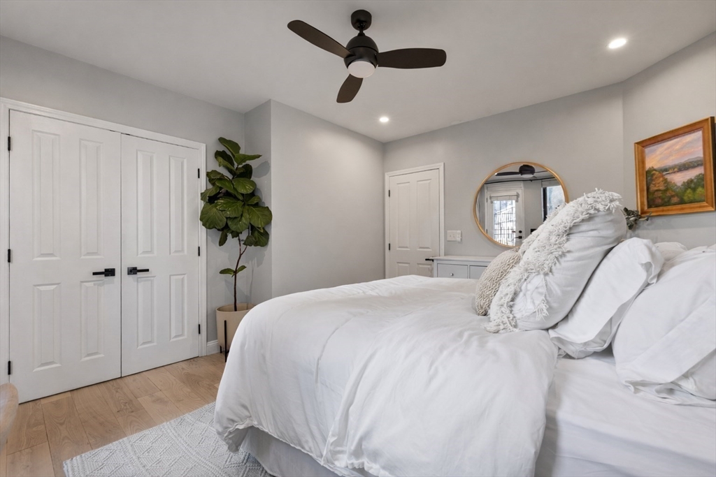 75 Clarendon Street, Unit 201 Boston, MA 02116 - Photo 6 of 12 a bedroom with a bed and a chandelier