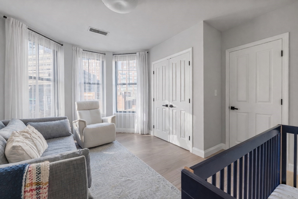 75 Clarendon Street, Unit 201 Boston, MA 02116 - Photo 7 of 12 a living room with furniture and a window