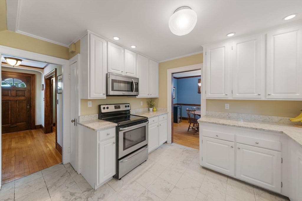 10 Parkview Road Reading, MA 01867 - Photo 11 of 31 a kitchen with granite countertop white cabinets and stainless steel appliances