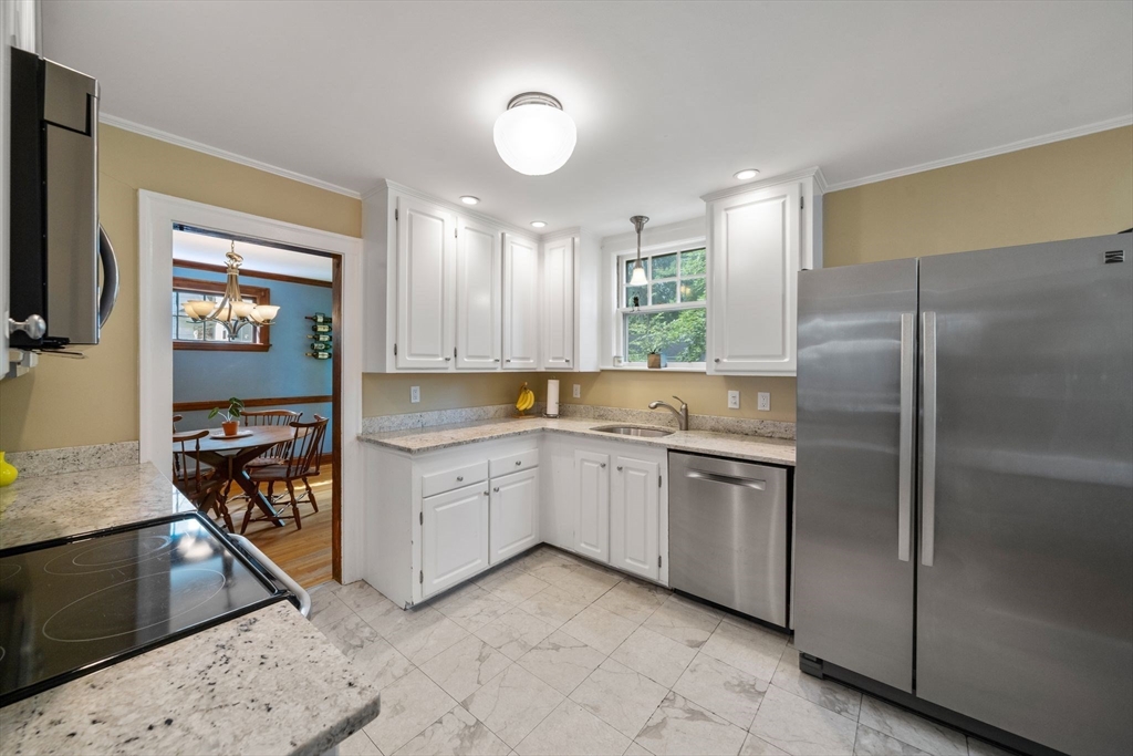 10 Parkview Road Reading, MA 01867 - Photo 12 of 31 a kitchen with a refrigerator and a sink