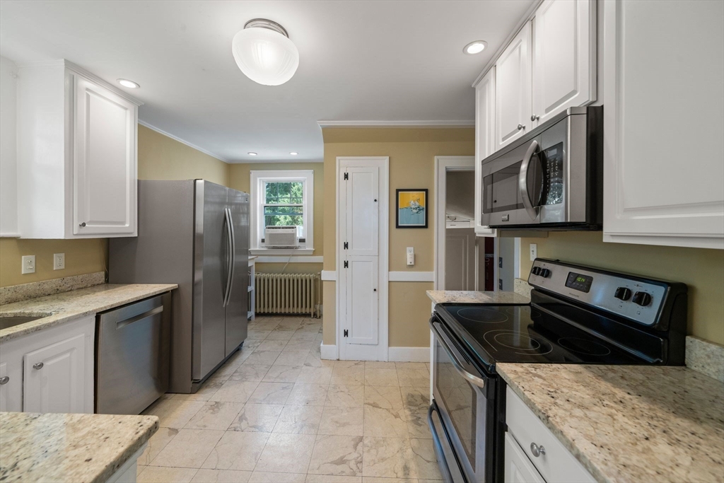 10 Parkview Road Reading, MA 01867 - Photo 13 of 31 a kitchen with stainless steel appliances granite countertop a sink stove and refrigerator