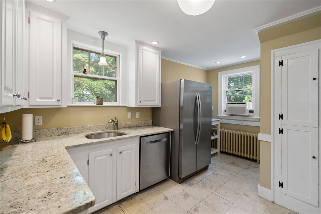 10 Parkview Road Reading, MA 01867 - Photo 14 of 31 a kitchen with a sink refrigerator and cabinets
