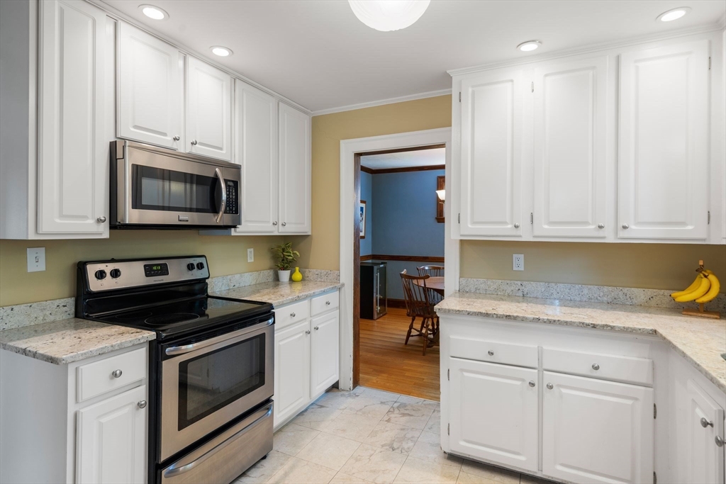 10 Parkview Road Reading, MA 01867 - Photo 15 of 31 a kitchen with granite countertop white cabinets and stainless steel appliances