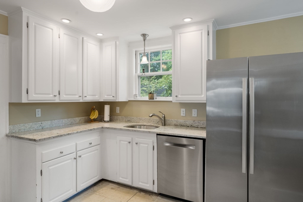 10 Parkview Road Reading, MA 01867 - Photo 16 of 31 a kitchen with a refrigerator sink and cabinets