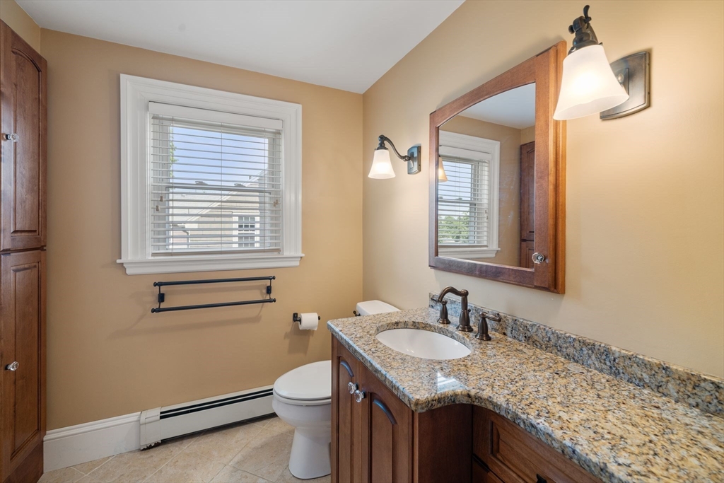 10 Parkview Road Reading, MA 01867 - Photo 20 of 31 a bathroom with a granite countertop sink toilet and mirror
