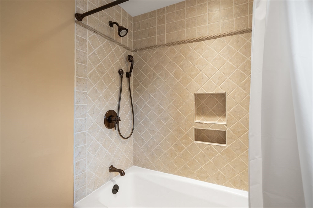 10 Parkview Road Reading, MA 01867 - Photo 21 of 31 a bathroom with a bath tub