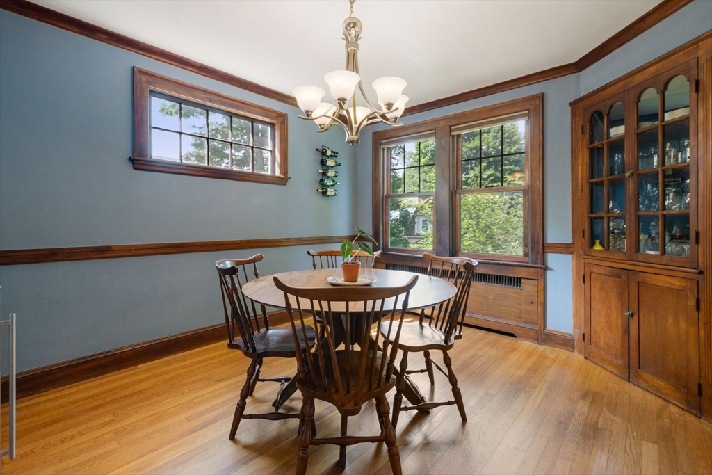 10 Parkview Road Reading, MA 01867 - Photo 10 of 31 a dining room with furniture a chandelier and wooden floor
