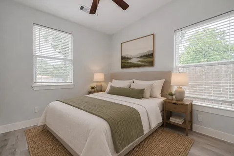 a bedroom with a bed and a window