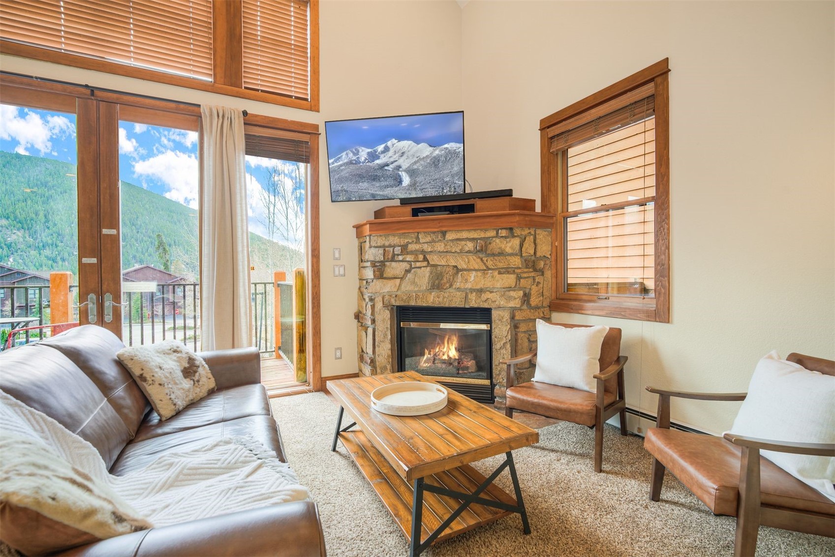 71 Antlers Gulch Road, Unit 303 Keystone, CO 80435 - Photo 3 of 35 a living room with furniture and a fireplace
