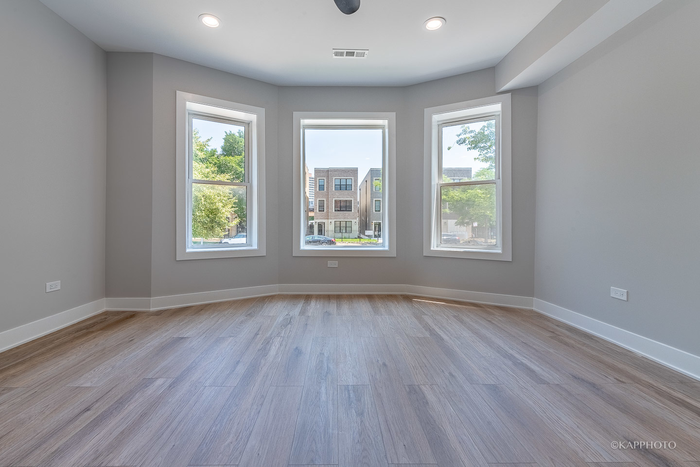 4152 South Prairie Avenue, Unit 1 Chicago, IL 60653 - Photo 12 of 27 an empty room with wooden floor and windows