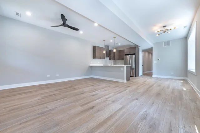 a view of a livingroom with hardwood floor and a ceiling fan