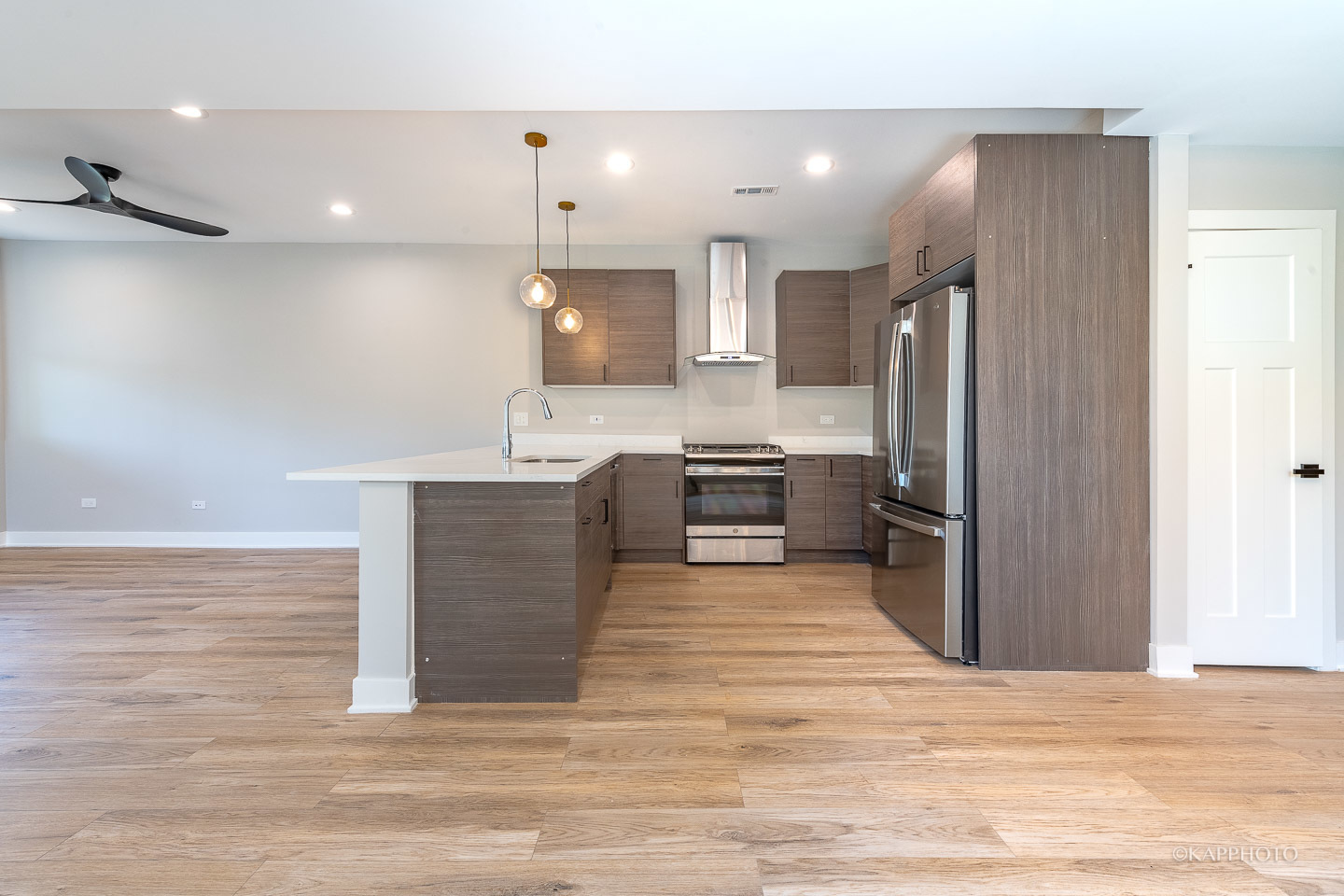 4152 South Prairie Avenue, Unit 1 Chicago, IL 60653 - Photo 2 of 27 a kitchen with stainless steel appliances kitchen island granite countertop a refrigerator a stove a sink and a microwave