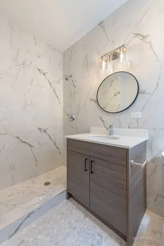 a bathroom with a sink mirror and vanity
