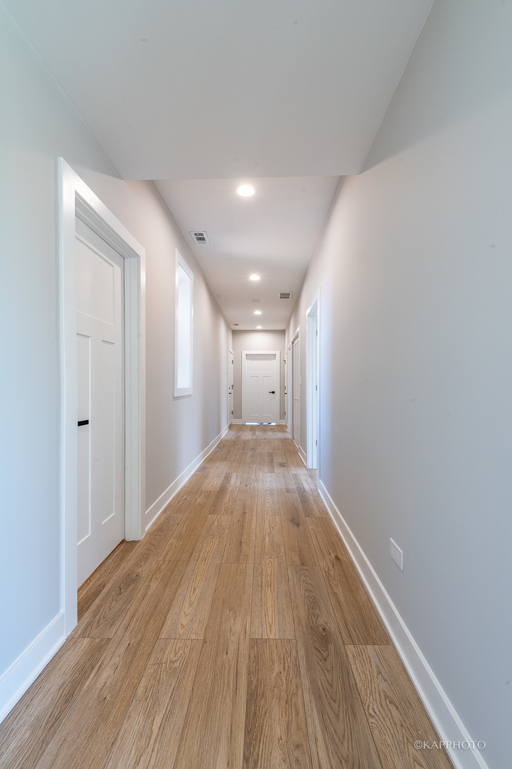 4152 South Prairie Avenue, Unit 1 Chicago, IL 60653 - Photo 7 of 27 a view of a big room with wooden floor and windows