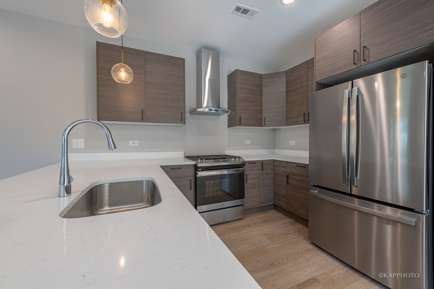 4152 South Prairie Avenue, Unit 1 Chicago, IL 60653 - Photo 9 of 27 a kitchen with stainless steel appliances granite countertop a refrigerator sink and stove