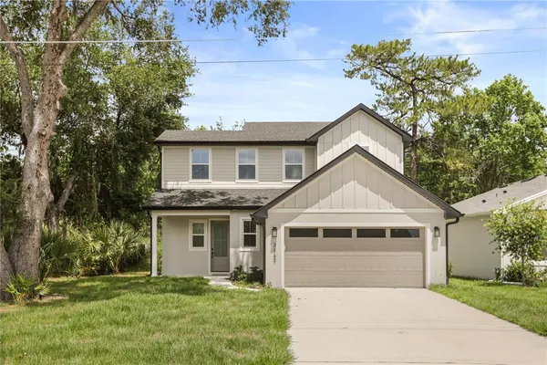 a front view of a house with a yard and garage