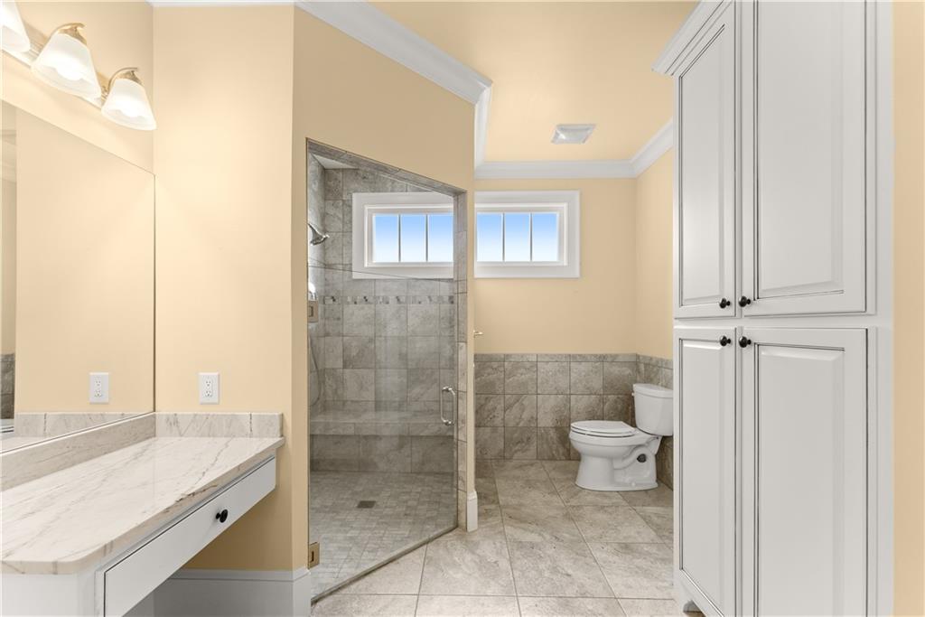 725 County Farm Road Jefferson, GA 30549 - Photo 29 of 66 a bathroom with a granite countertop sink a toilet and shower