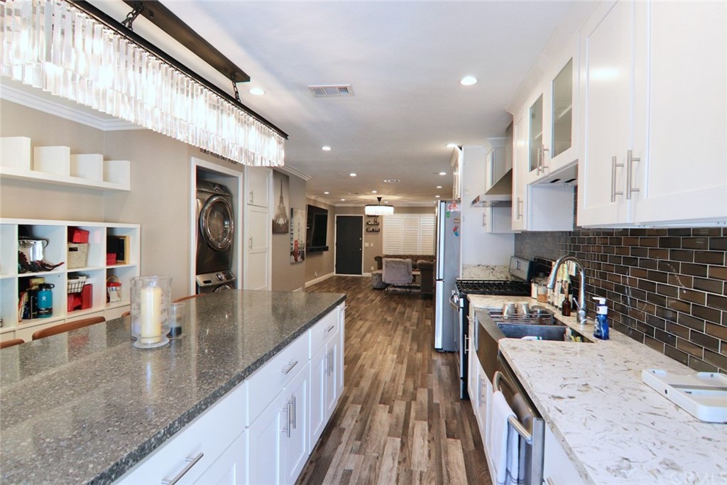 a kitchen with a sink a counter top space stainless steel appliances and a counter top space