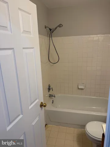 a bathroom with a toilet and a bath tub