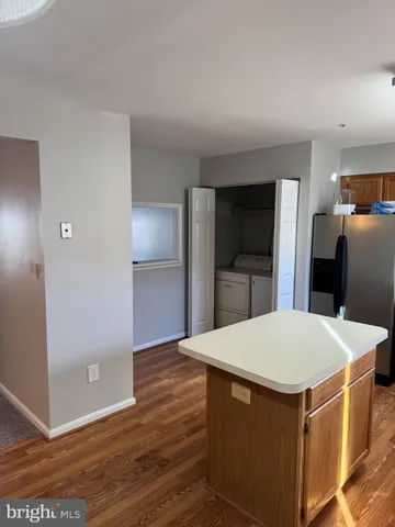 a kitchen with stainless steel appliances a refrigerator and microwave