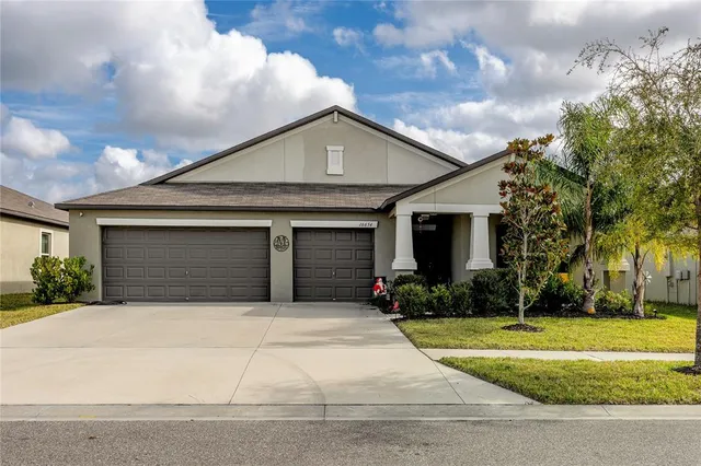 a front view of a house with a yard and garage