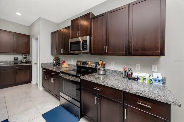 a kitchen with granite countertop cabinets stainless steel appliances and a sink