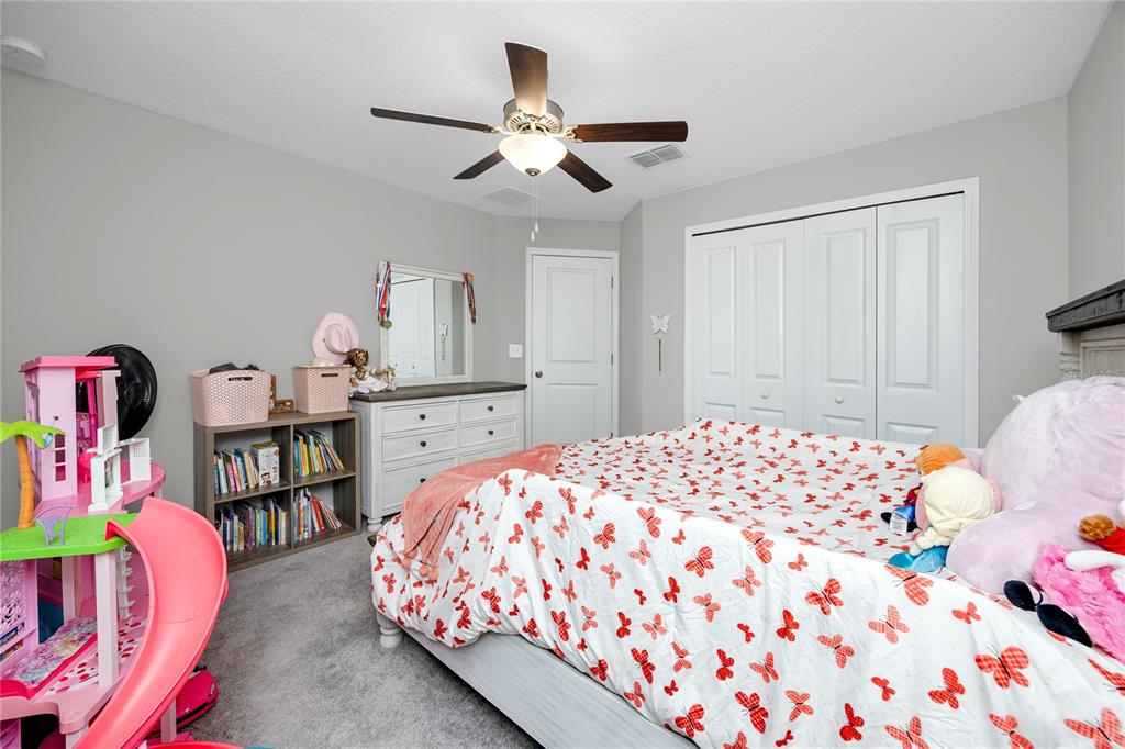 16654 Carlton Pond Street Wimauma, FL 33598 - Photo 19 of 48 a bedroom with a bed and closet