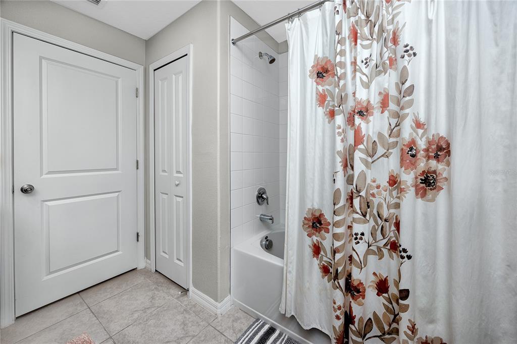16654 Carlton Pond Street Wimauma, FL 33598 - Photo 21 of 48 a bathroom with a bathtub and shower