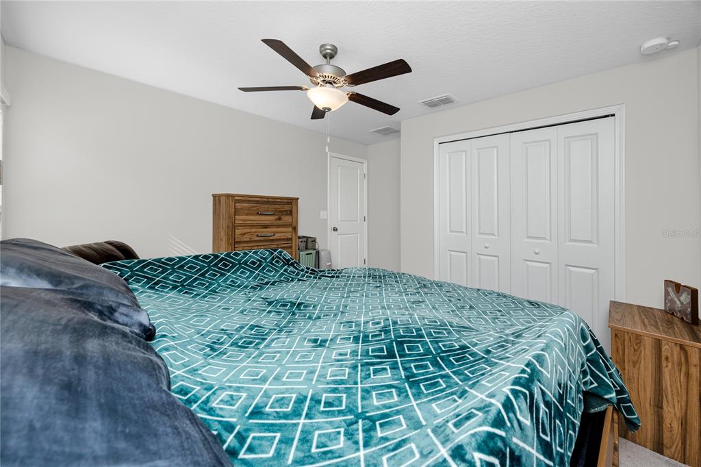 16654 Carlton Pond Street Wimauma, FL 33598 - Photo 23 of 48 a bed in a room next to a window