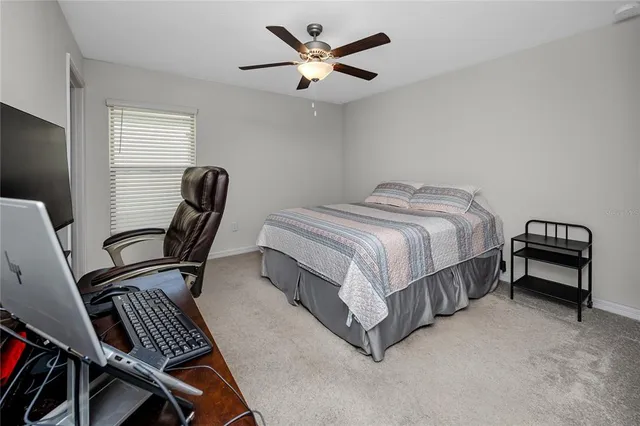 a bed room with a bed and a chair