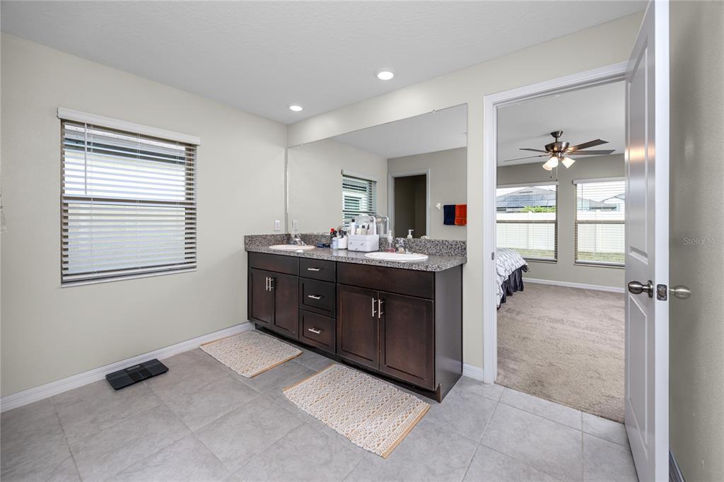 16654 Carlton Pond Street Wimauma, FL 33598 - Photo 31 of 48 a room with a dresser and a window