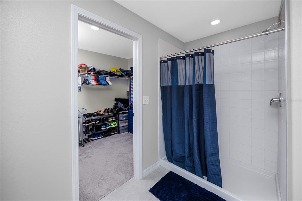 16654 Carlton Pond Street Wimauma, FL 33598 - Photo 32 of 48 a view of walk in closet with clothes and shoes