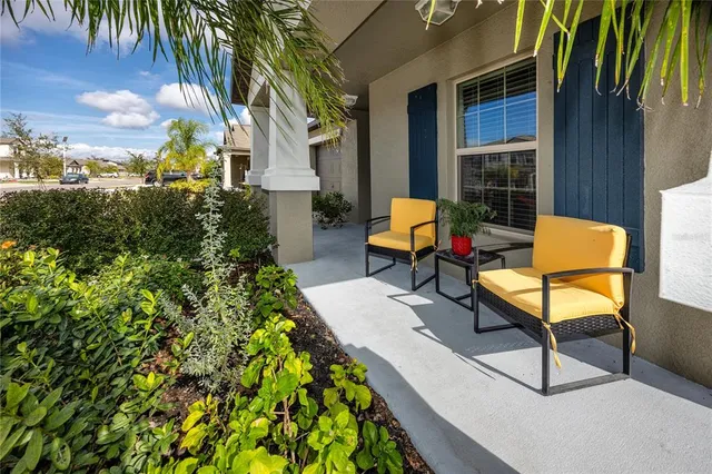 a backyard of a house with fountain table and chairs